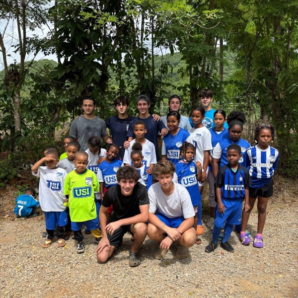 Give & Goal Project team with kids in donated jerseys in Las Auyamas, Dominican Republic