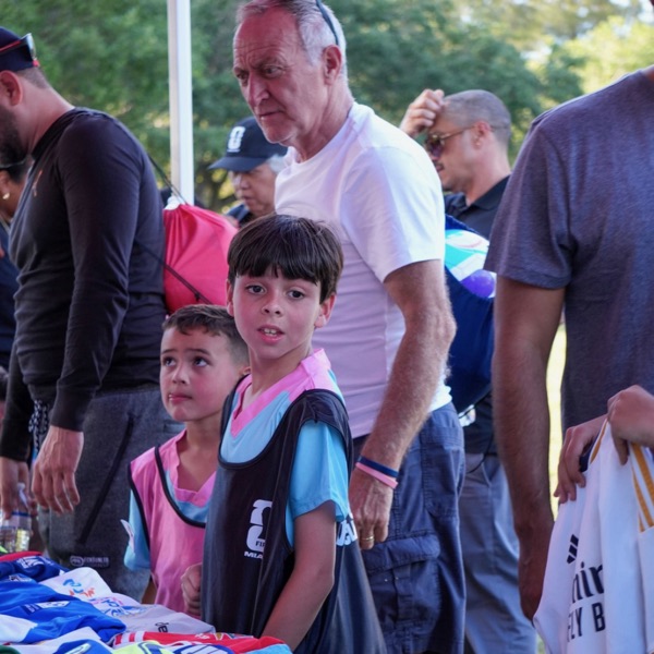 A boy picking a donated jersey at the FIFA World Cup Miami 26 youth clinic