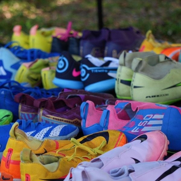 Rows of donated cleats at the FIFA World Cup Miami 26 clinic